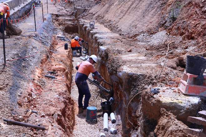  Contractors drilling through concrete piles
