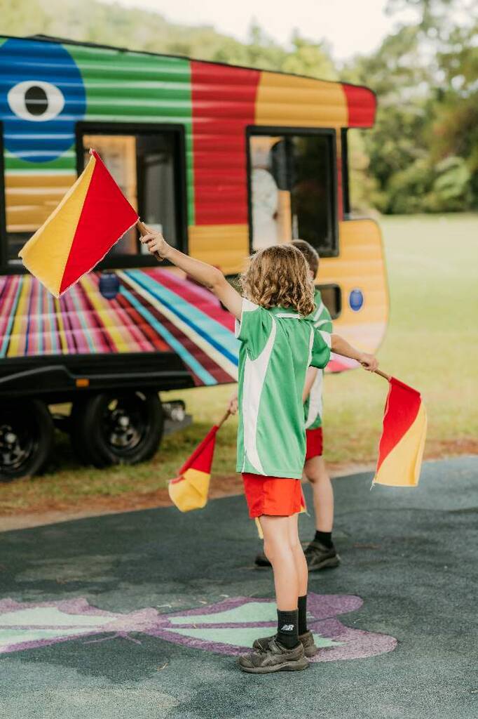 Students try their hand at flag signalling, one of the communication methods explored in the Connected: Signal to the Stars exhibition.