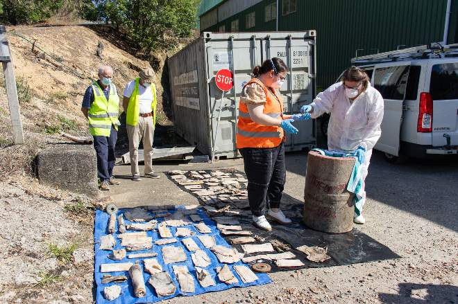 Council staff and former Apex members examining Apex community time capsule contents